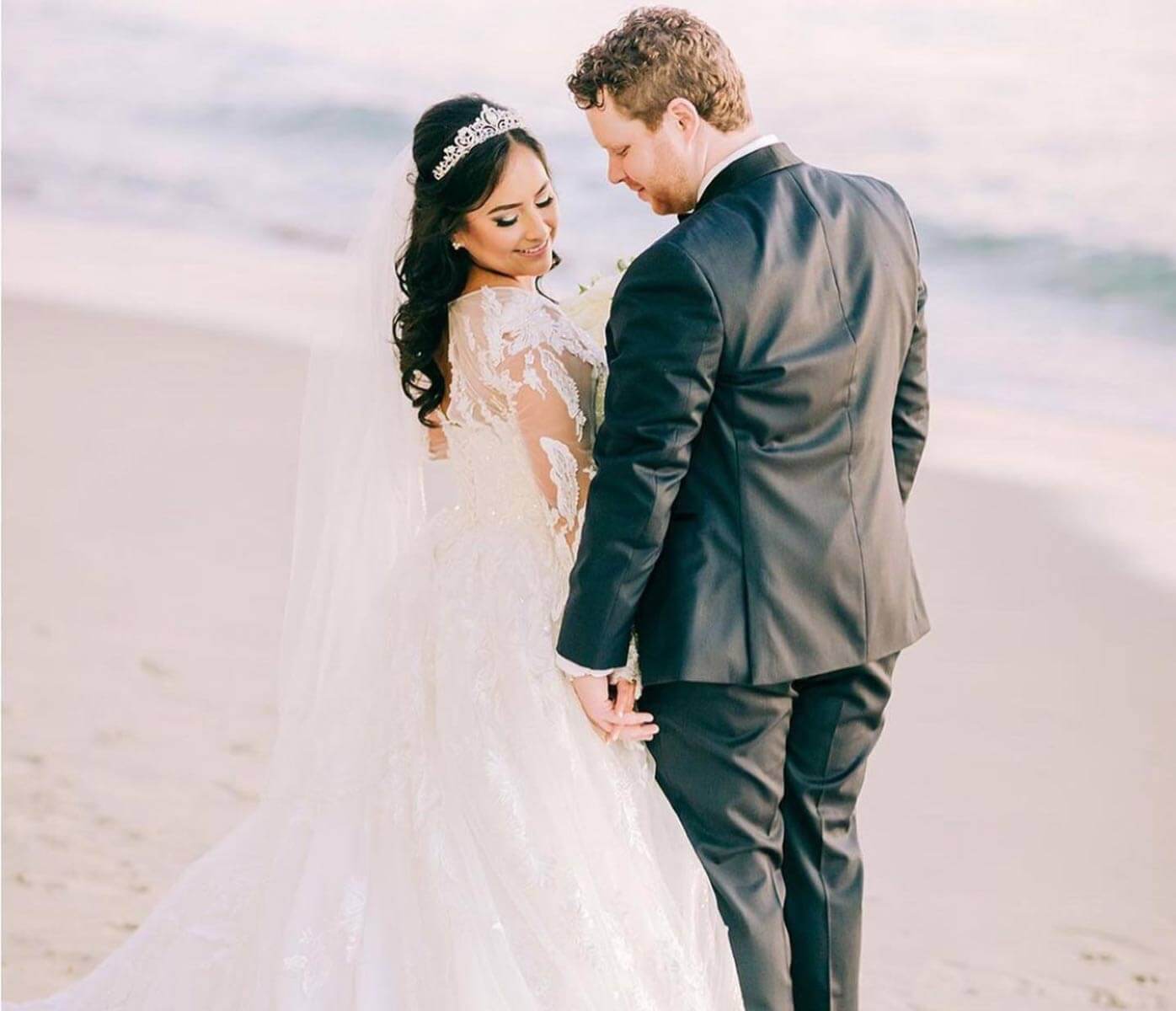 Сouple wearing a white gown and a black suit