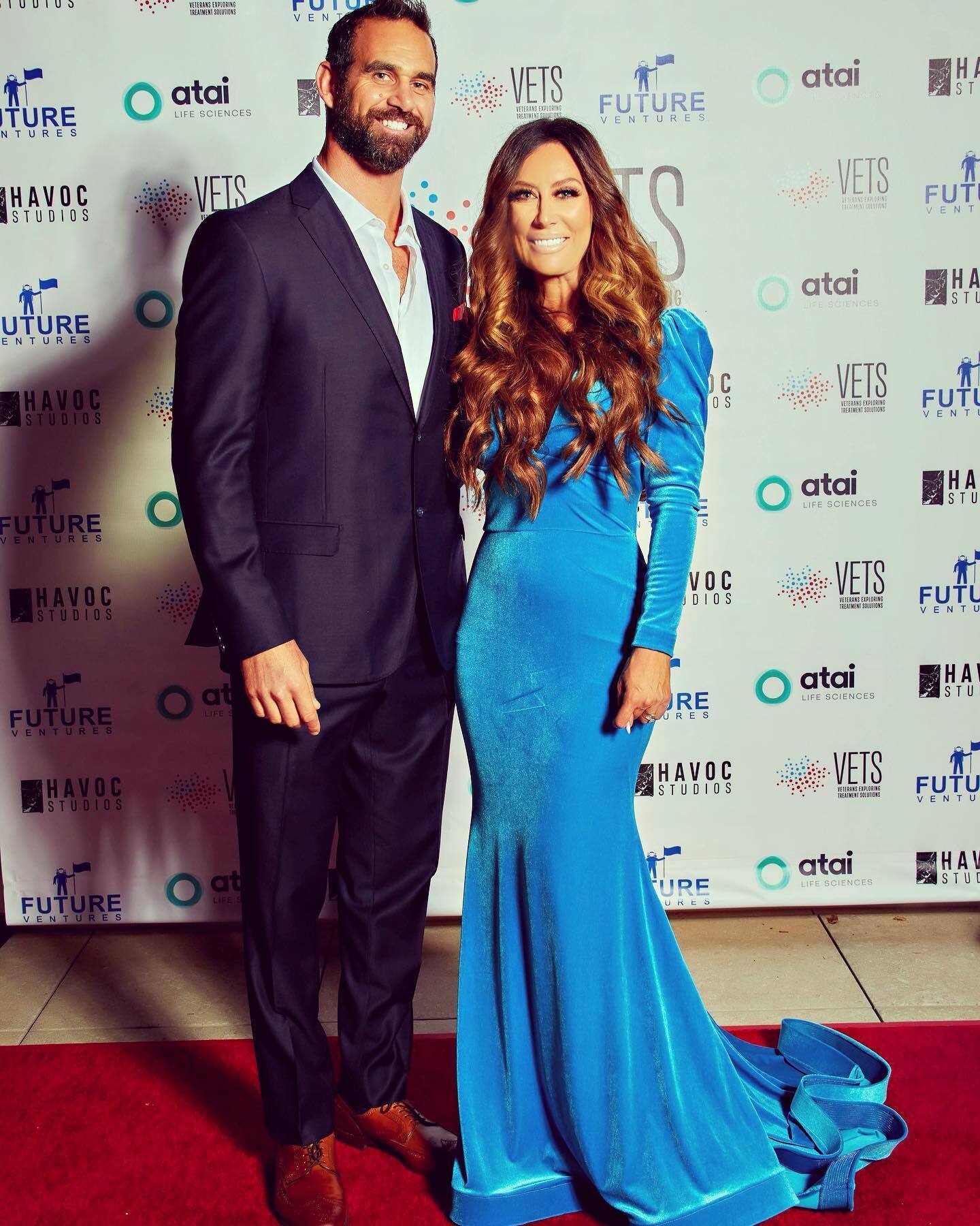 Сouple wearing a blue gown and a black suit